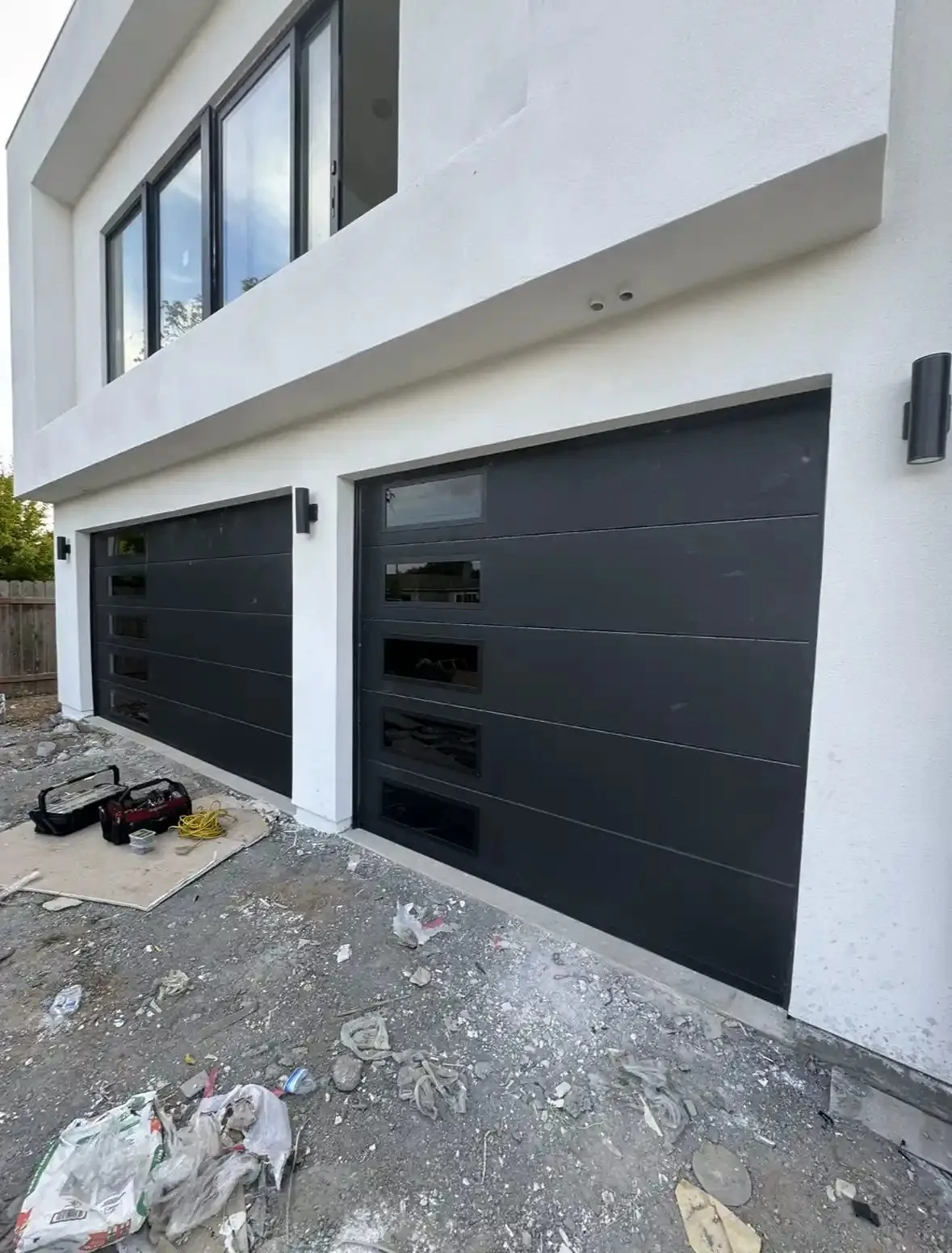 Black sectional garage doors during installation